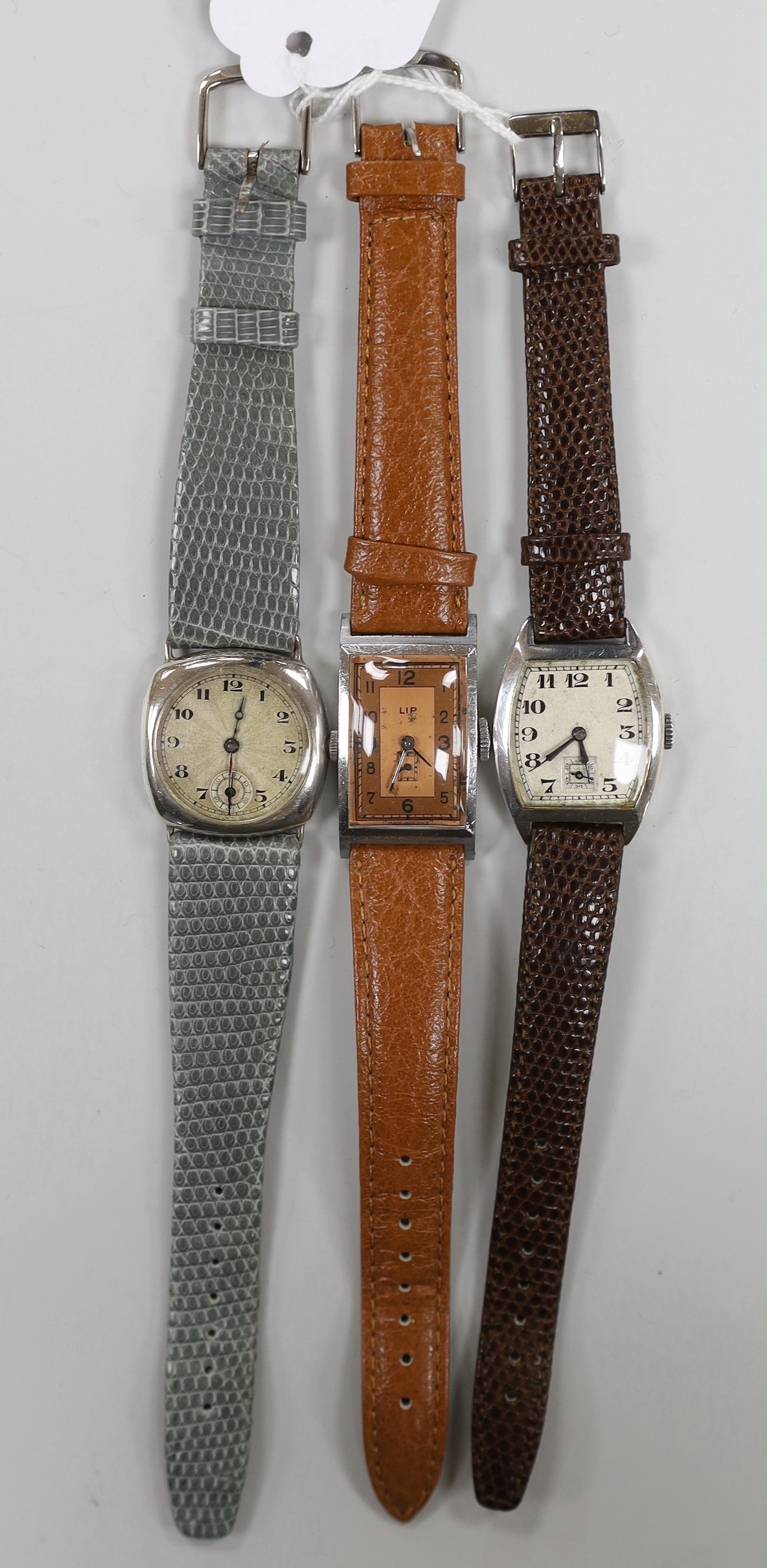 A gentleman's 1930's? silver manual wind wrist watch, with sunburst Arabic dial and subsidiary seconds, one other similar silver manual wind tonneau cased wrist watch and a stainless steel LIP manual wind wrist watch.
